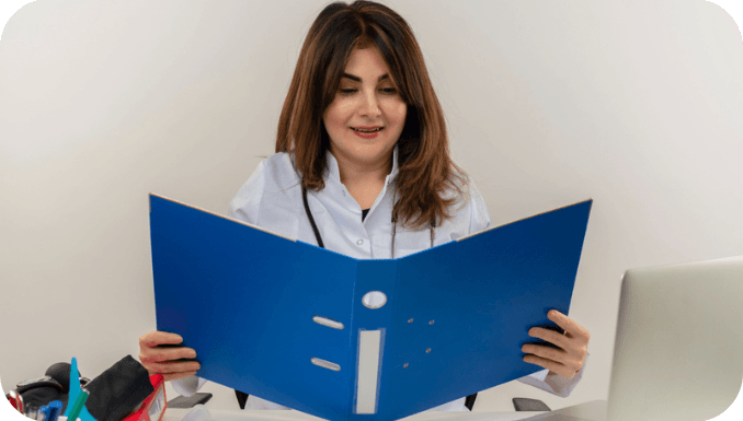 Doctor-reading-files-for-Principal-Care-Management.