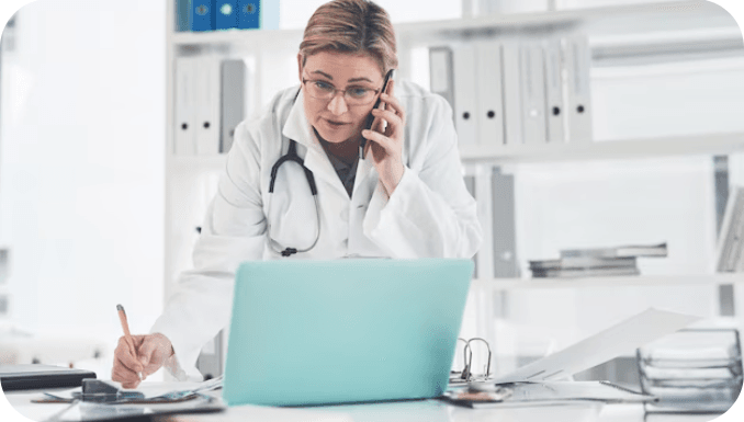 Female-doctor-busy-on-phone-and-laptop
