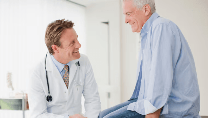 Hospital-doctor-happily-conversing-with-patient.