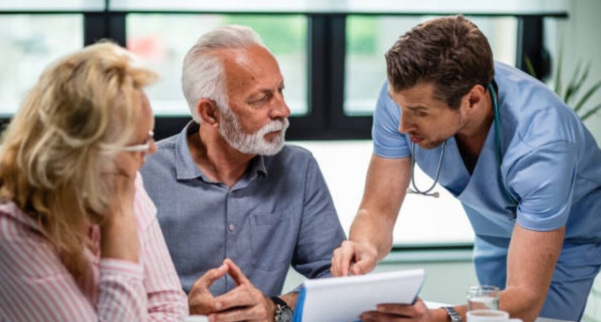 doctor-explains-medical-documents-pcm-medicare-billing-to-senior-couple
