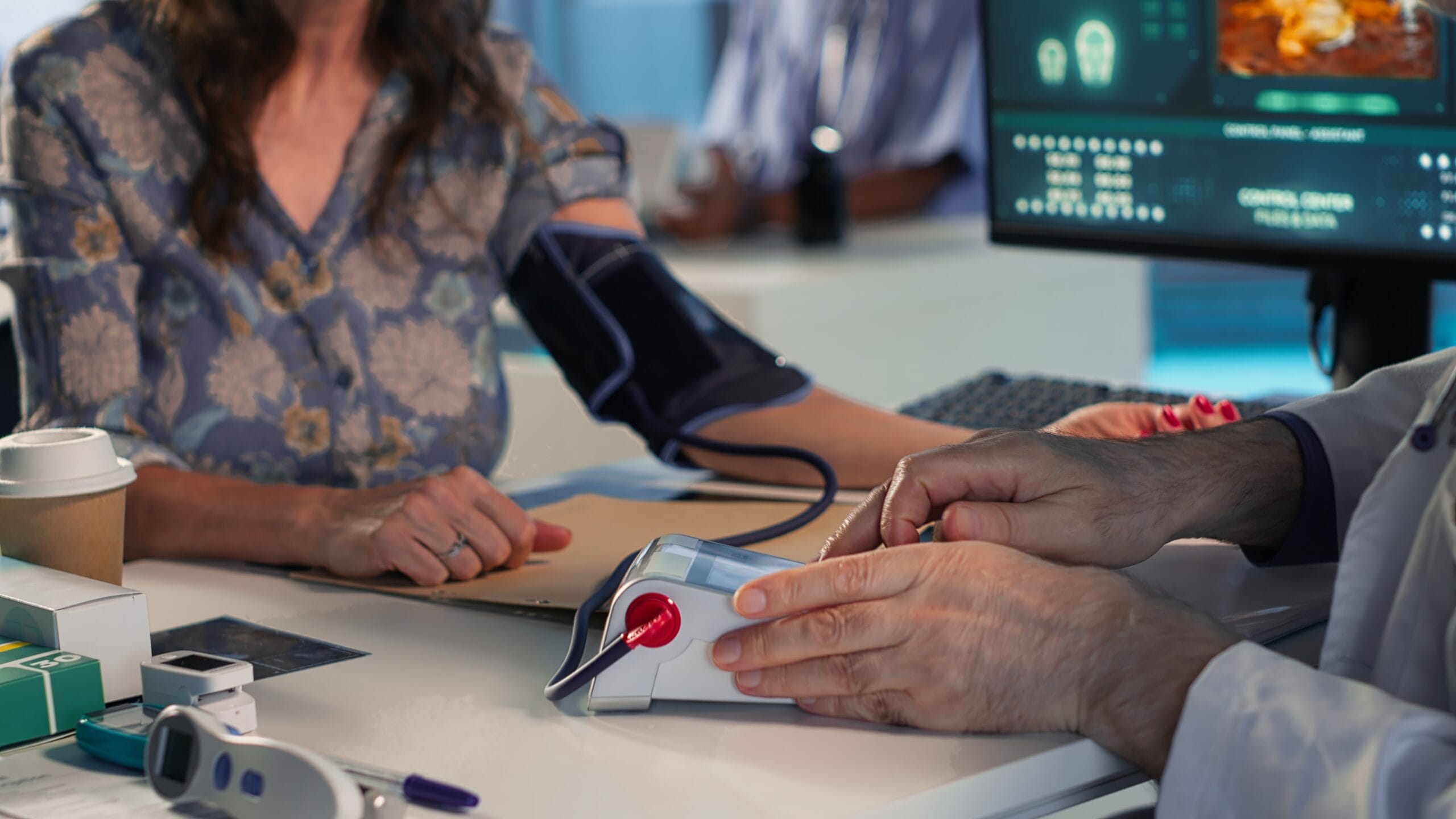 Doctor checking a patient’s vital signs in a clinical setting, illustrating RPM Billing for Chronic Conditions such as hypertension, diabetes, and COPD.
